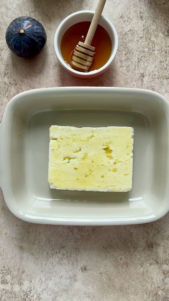 Brushing the feta with olive oil.