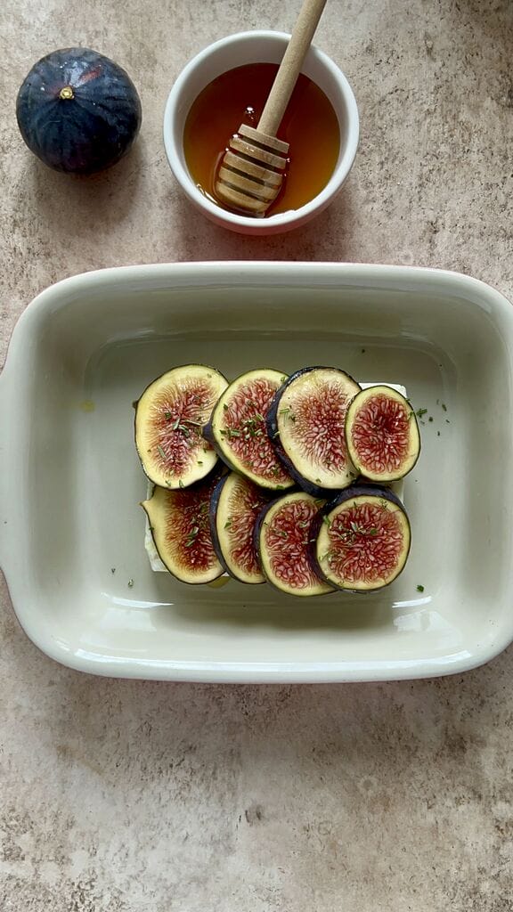 Sprinkling the figs with chopped rosemary.