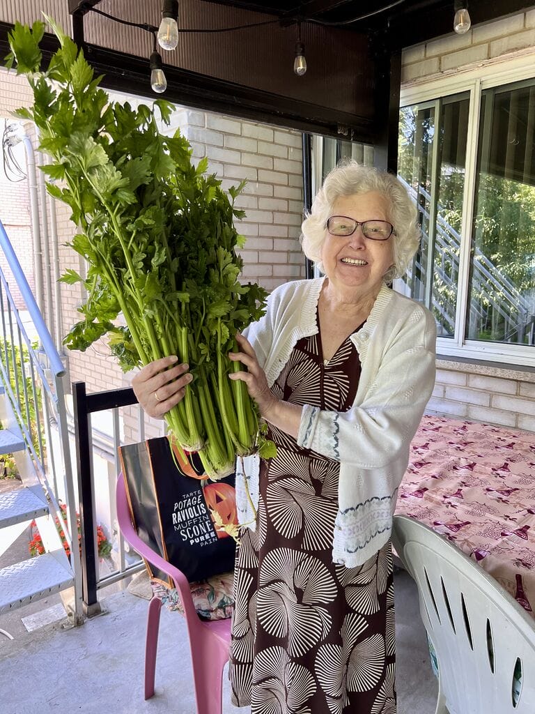 My mom holding the celery from the garden.