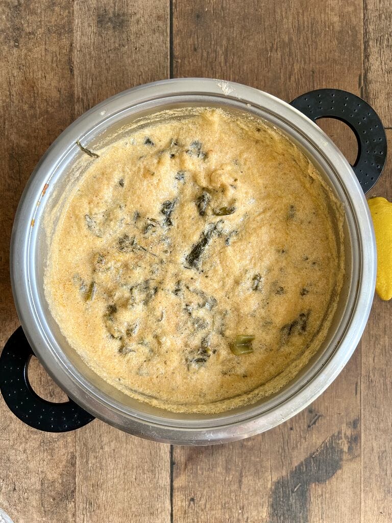 Pork and celery with egg lemon sauce in a saucepot