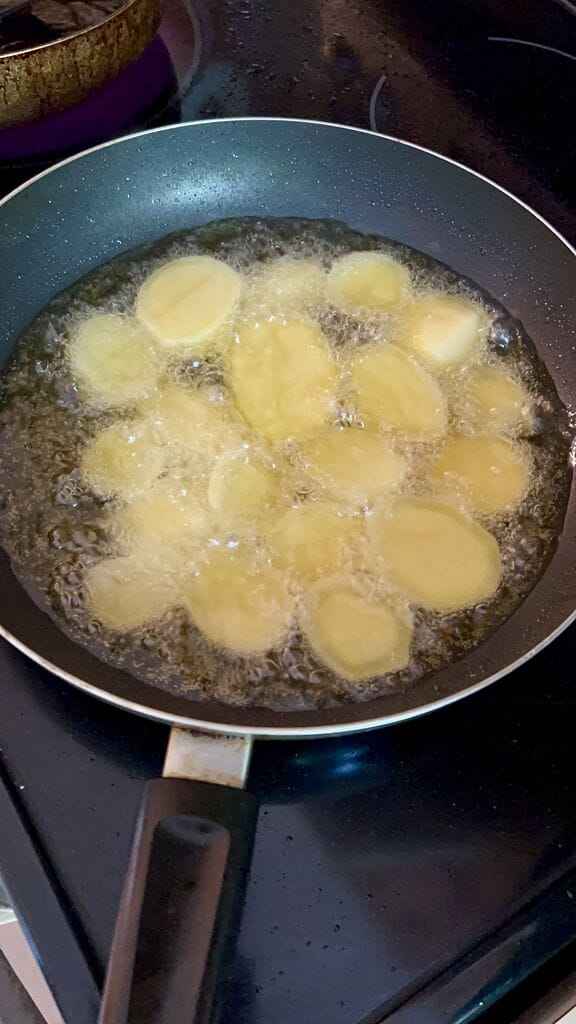 Frying the potatoes.