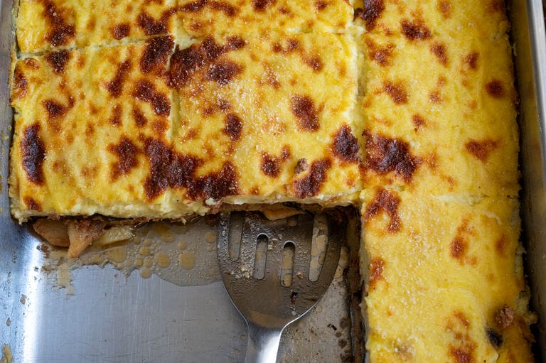 Moussaka in a stainless steel pan.