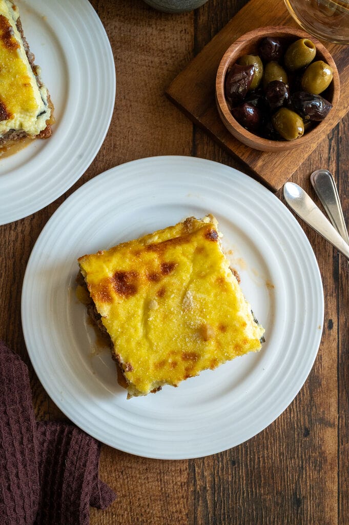 A piece of moussaka on a white plate.