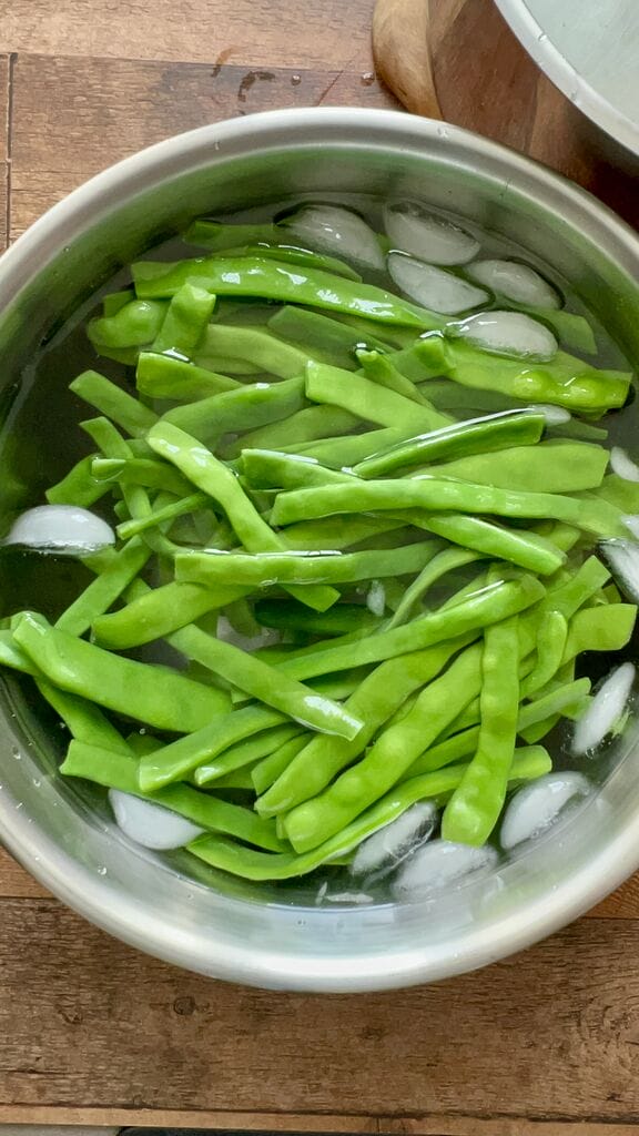 Cooling off the green beans in ice water.