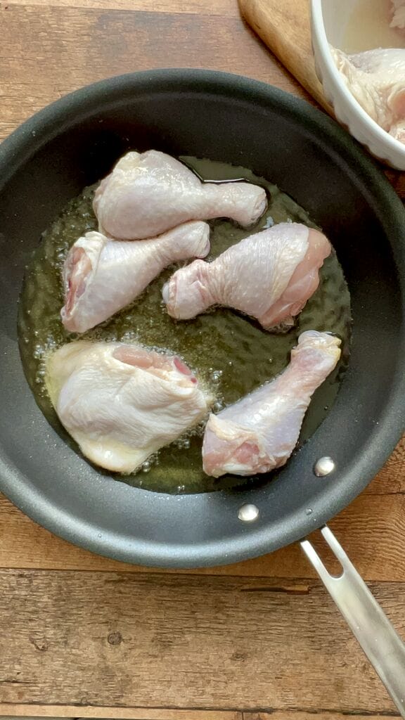 Frying the chicken pieces.