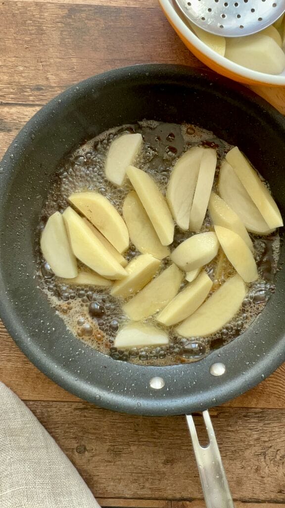 Frying potato wedges.