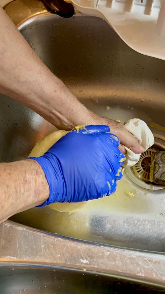 Squeezing out excess liquid.