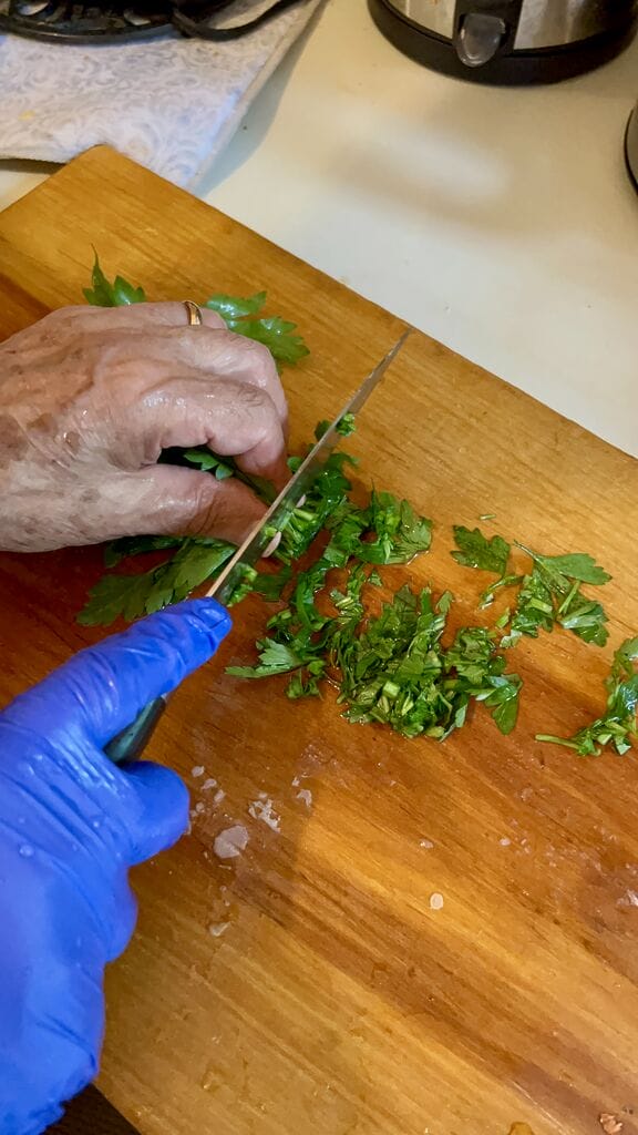 Chopping up parsley.