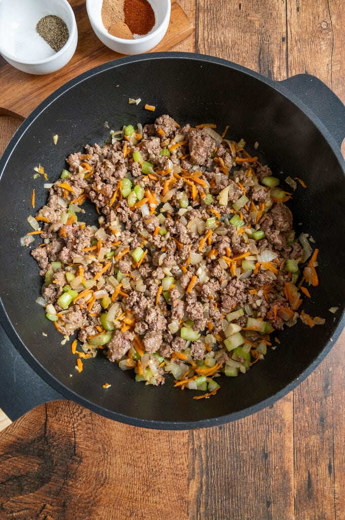 Frying the ground beef.