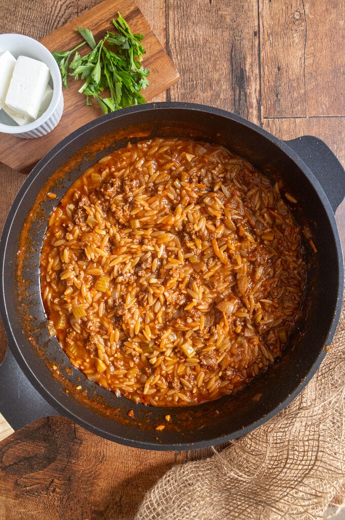 Greek orzo with ground beef, Youvetsi me kima stin katsarola, in a frying pan.