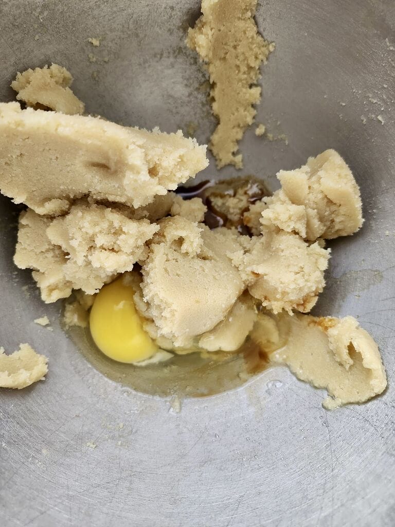 Combining the egg with sugar mixture.