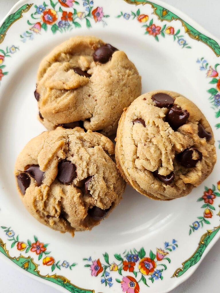 Lenten chocolate chip cookies on a white plate with green trimmings.
