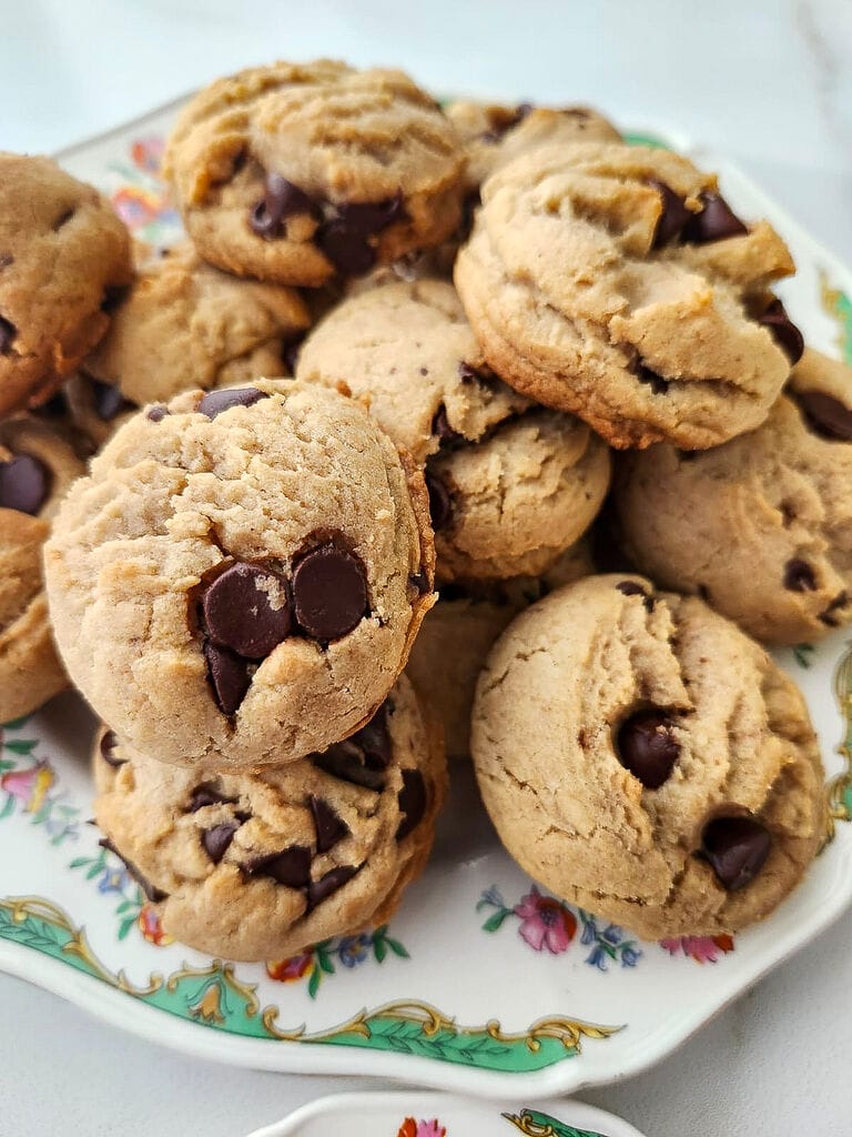 Lenten chocolate chip cookies on a white plate with green trimmings.
