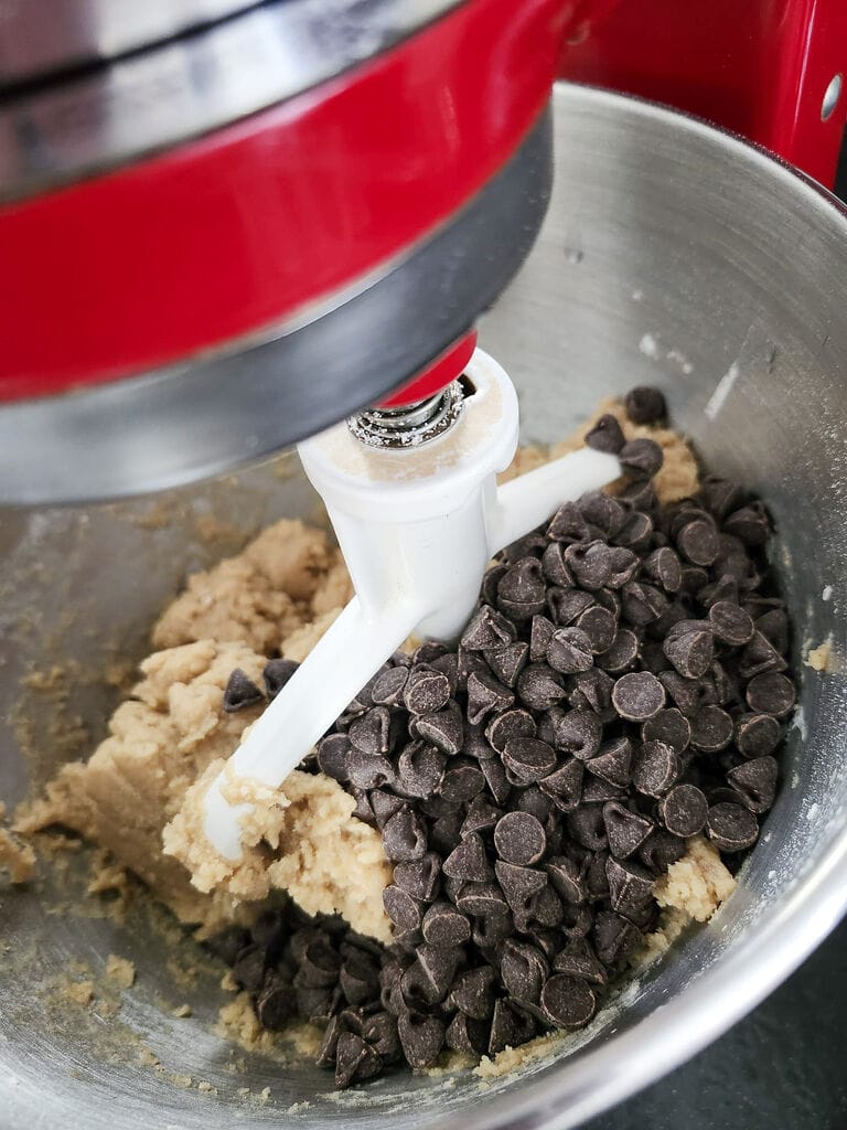 Combining the chocolate chips into the batter.