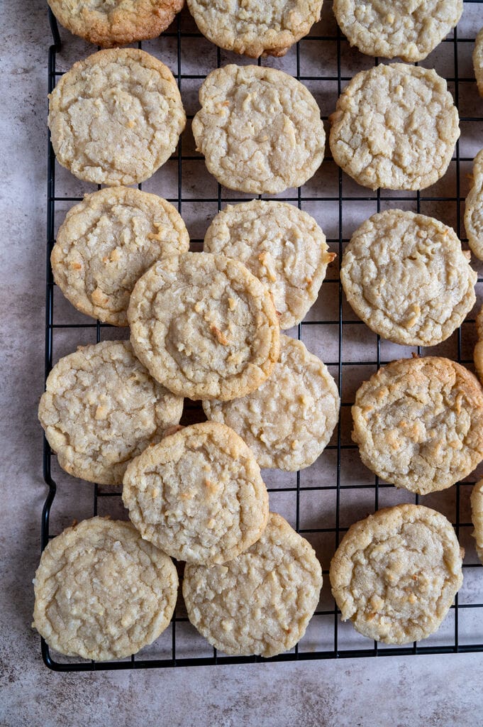 Chewy coconut cookies displayed on a wire cooling rack.
