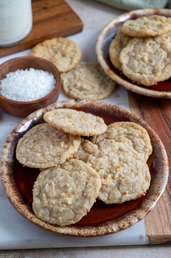 Chewy coconut cookies displayed on a marble board.