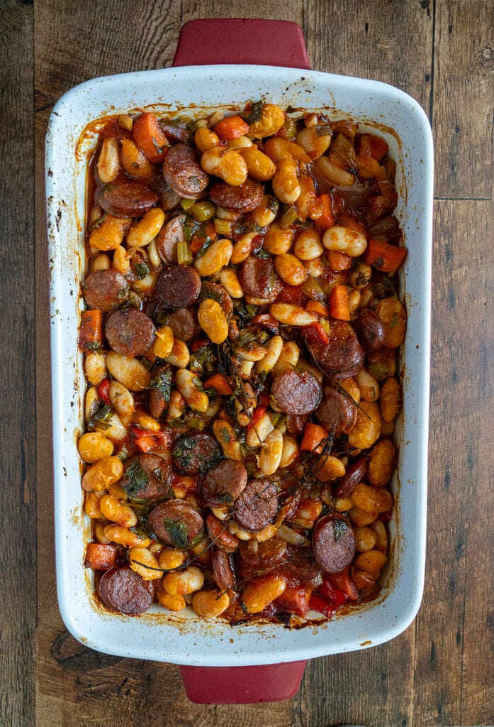 Greek Baked Gigantes with Sausage (Loukaniko), cooked and in a roasting pan.