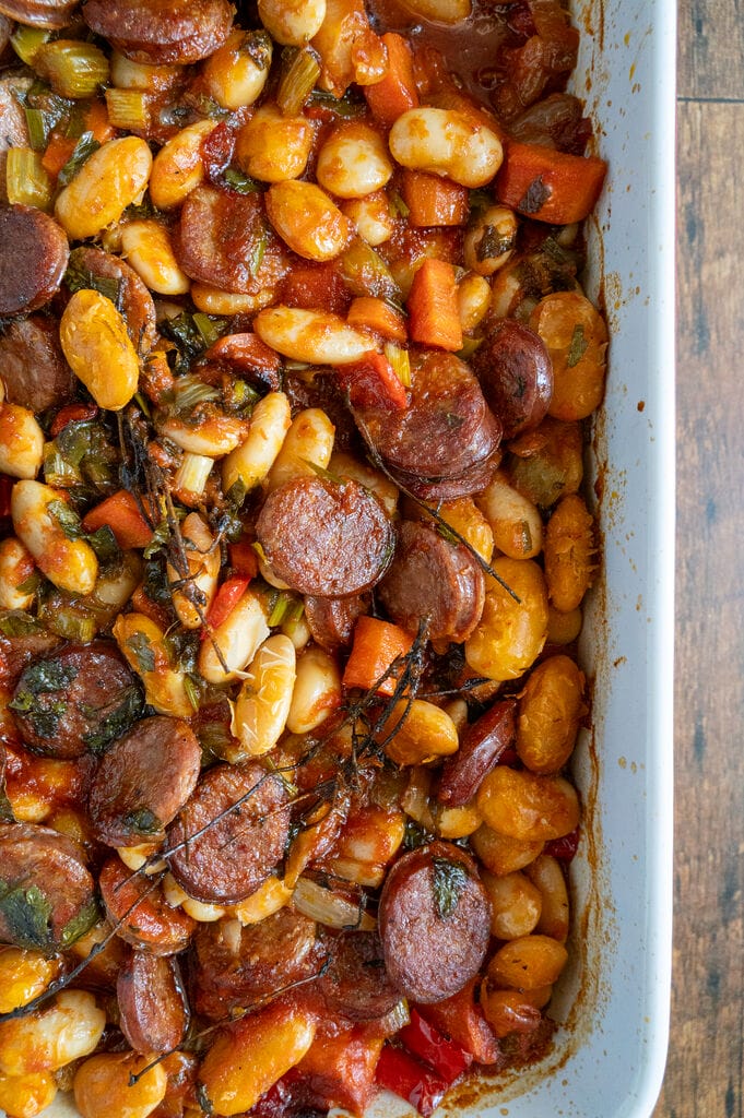 Greek Baked Gigantes with Sausage (Loukaniko), cooked and in a roasting pan.