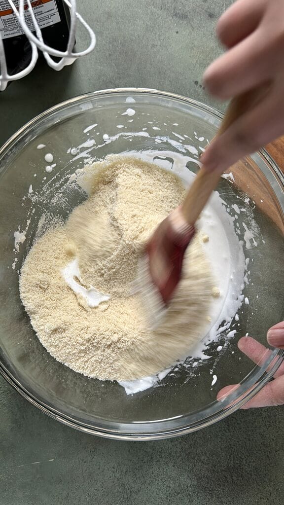 Adding in the almond flour to the egg/sugar mixture.