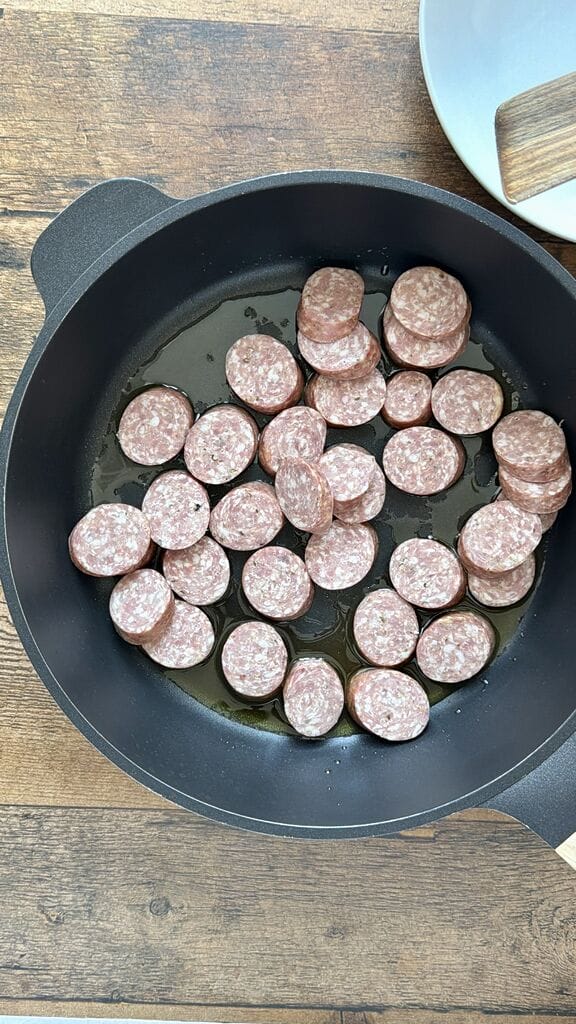 Frying the sausage rounds.