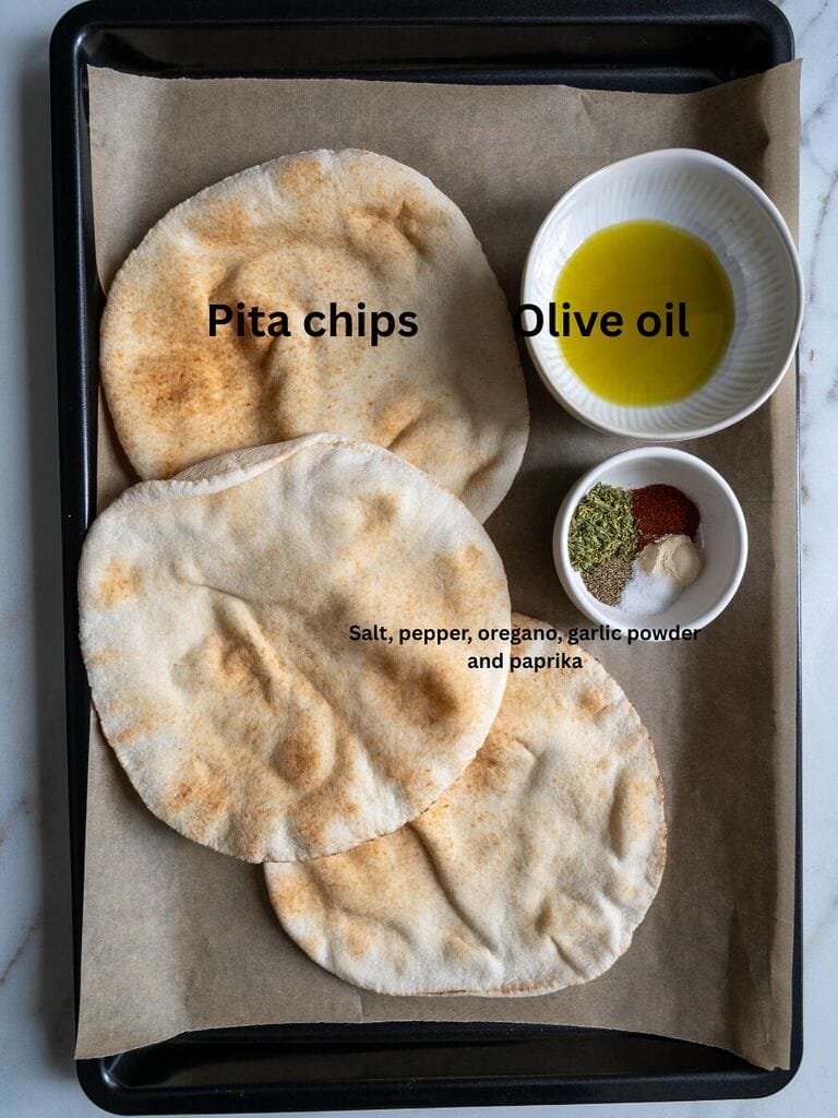 Ingredients which include: Pita chips, Olive oil, Salt, Pepper, Oregano, Garlic powder, and paprika.