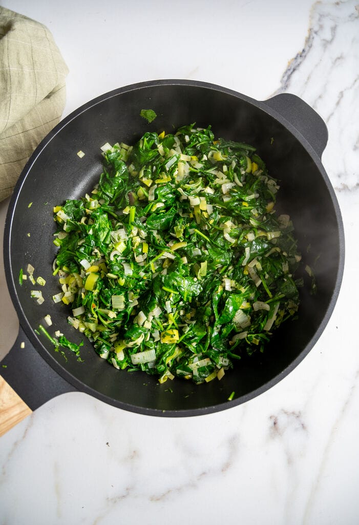Sautéing the spinach with the leek, shallots and garlic and spinach.