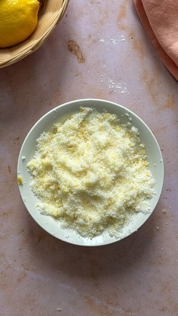 Mixing the sugar and lemon zest together using your fingers.