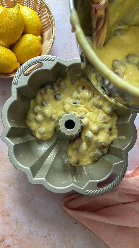 Adding the cake batter into the cake pan.