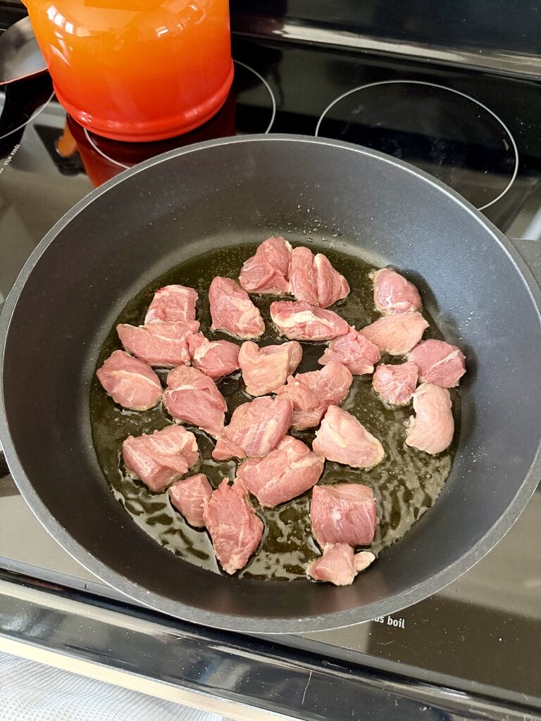 Browning the meat.