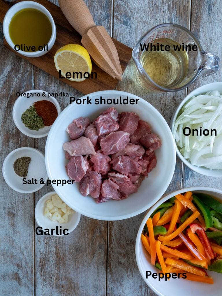 Ingredients include: Pork shoulder, white wine, onion, peppers, olive oil, oregano, paprika, salt, pepper, garlic and lemon juice.