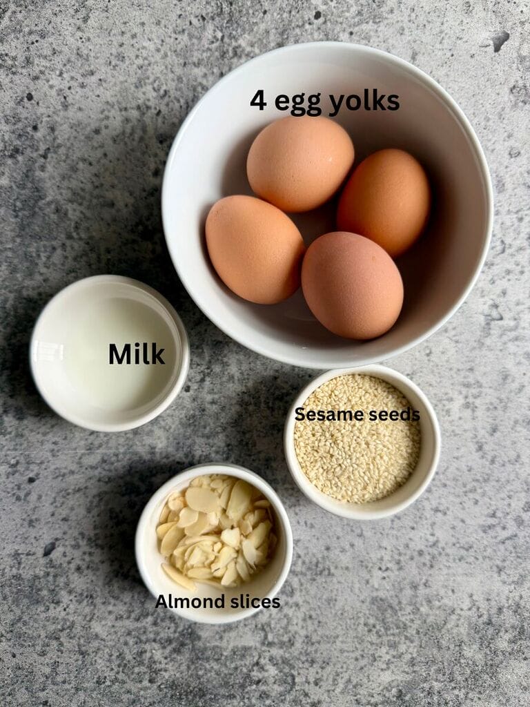 Ingredients for the topping include: 4 egg yolks, milk, sesame seeds and/or almond slices.