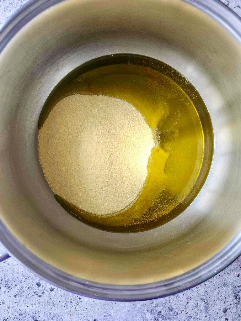 Combining the semolina with olive oil.