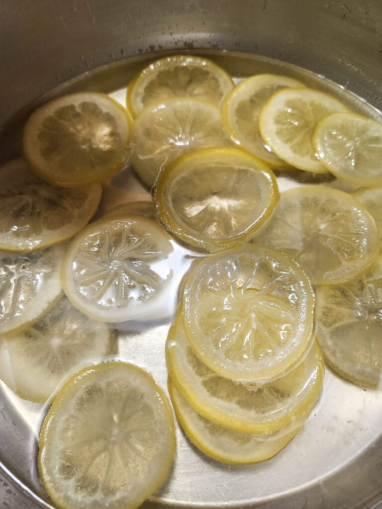 Boiling the lemon slices.