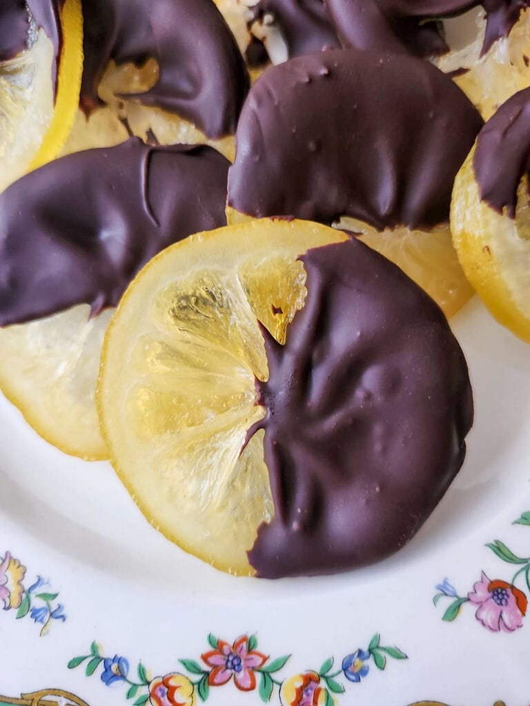 Candied lemon slices half dipped in dark chocolate.