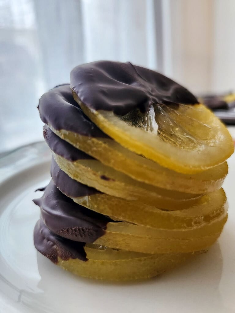 Candied lemon slices half dipped in dark chocolate.