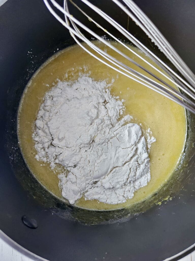 Adding the flour into the egg/sugar/butter mixture.