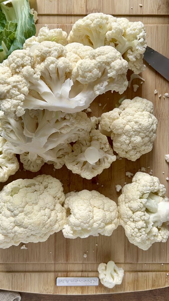 Cutting cauliflower into large florets.