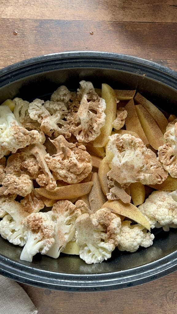 Greek braised cauliflower in a roasting pan with potatoes.