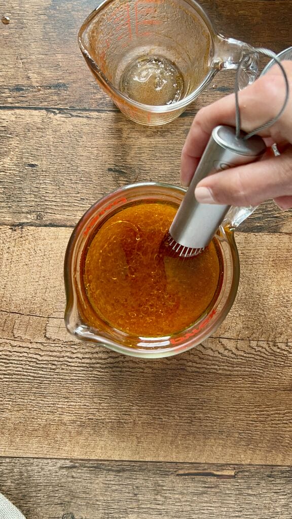 Combining the tomato sauce, olive oil and water.
