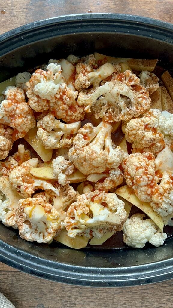 Greek braised cauliflower in a roasting pan with potatoes.