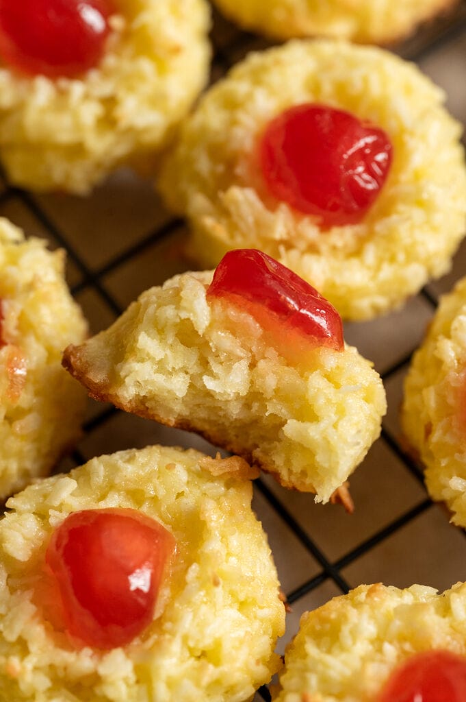 The cookies on a baking rack. One of the cookies is showing what it looks like on the inside.