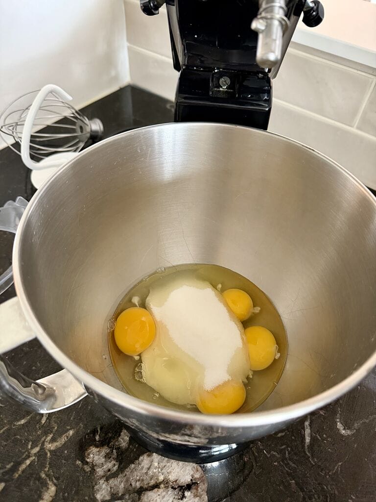 Combining the sugar and eggs.