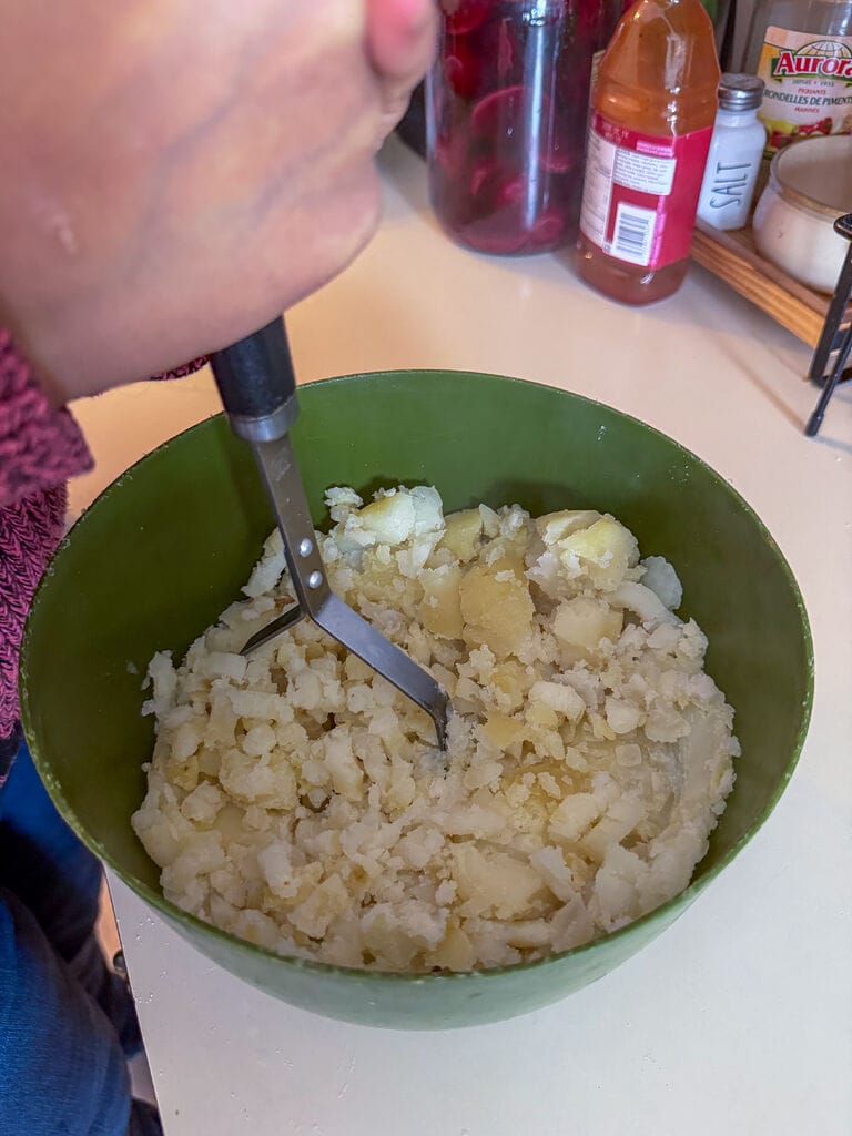 Mashing the potatoes.