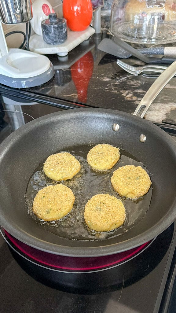 Frying the fritters in oil.