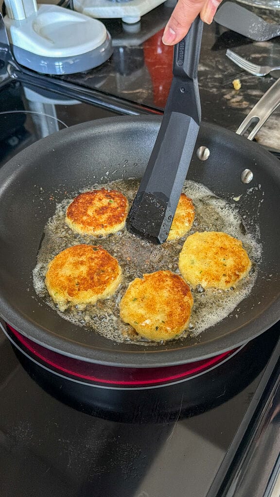 Frying the fritters in oil.