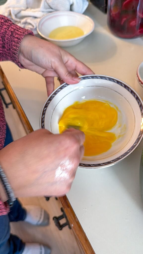 Beating the eggs.
