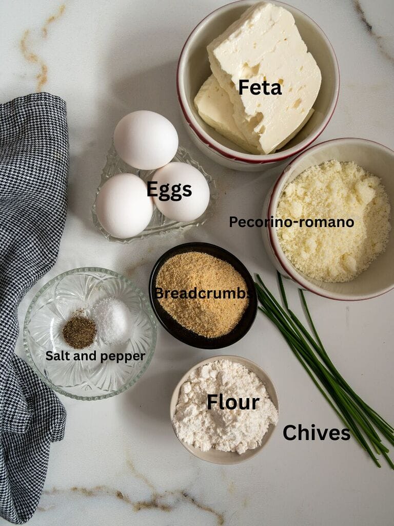 Ingredients for potato fritters include potatoes, eggs, feta, pecorino romano cheese, salt, pepper, breadcrumbs, flour and chives.