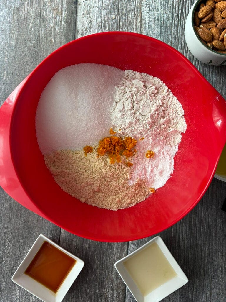 Combining the ingredients in a red bowl.