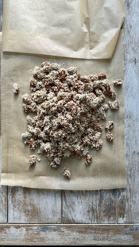 Spreading out the caramelized almonds, so they can separate and cool.