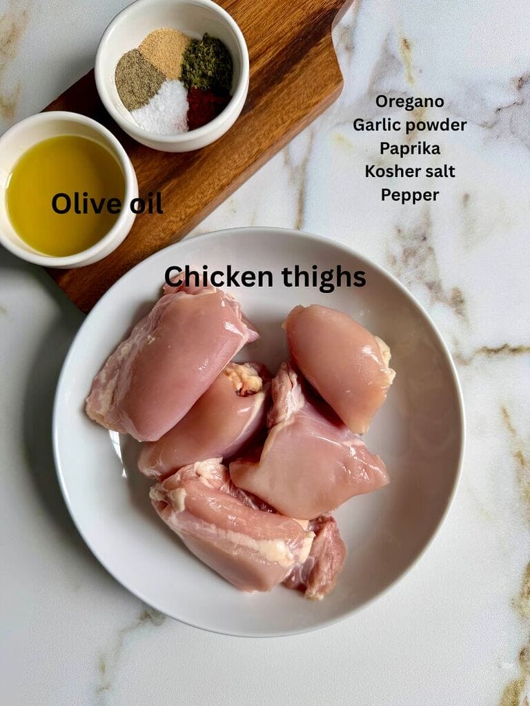 Marinade ingredients for the chicken include: Chicken thighs, olive oil, oregano, garlic powder, paprika, kosher salt and pepper.